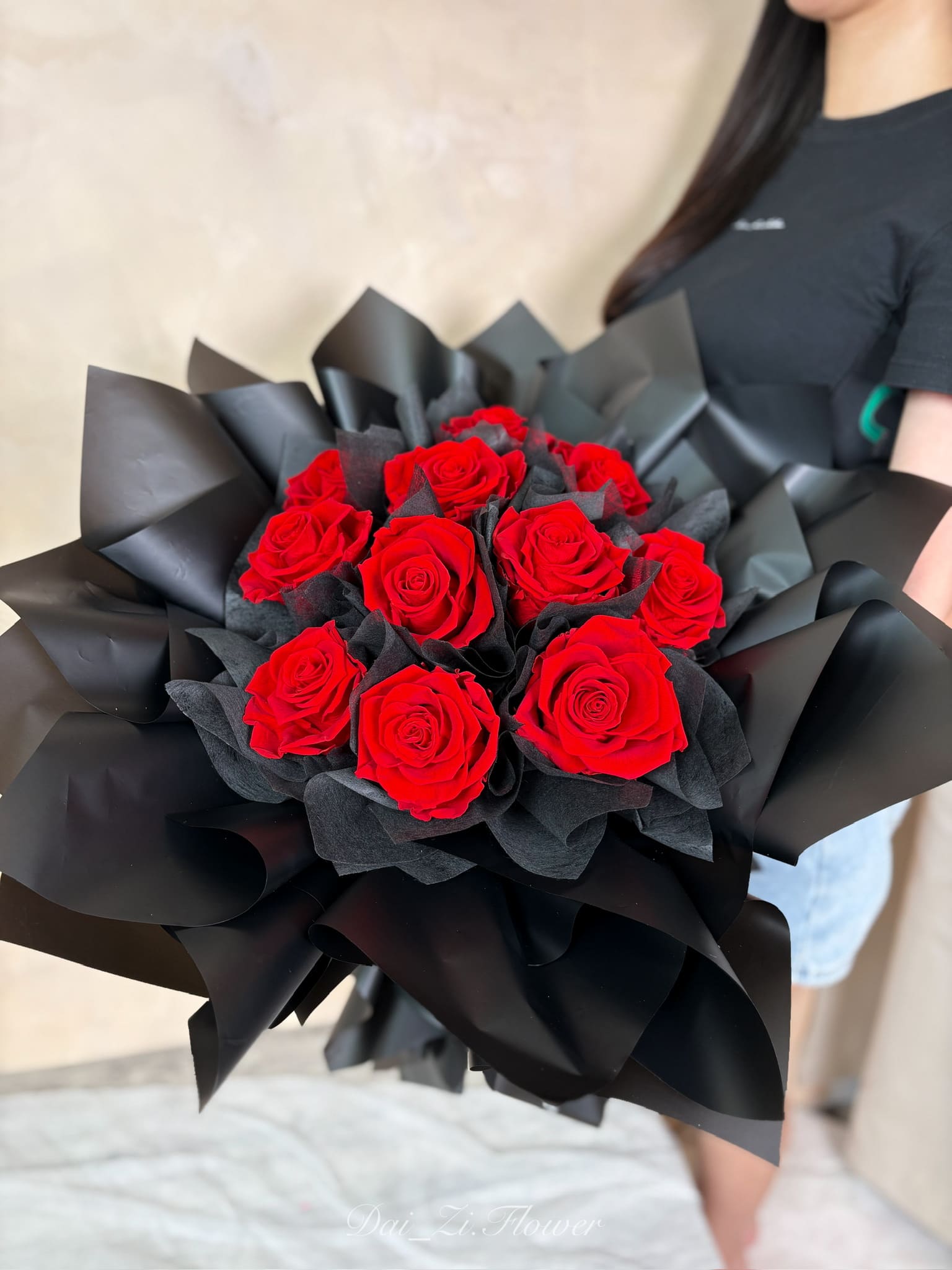DAIZI代紫花藝-手持經典11朵紅永生花束實拍，搭配神祕奢華黑色包裝設計，大台北地區客製化求婚花束與極致告白花禮推薦。