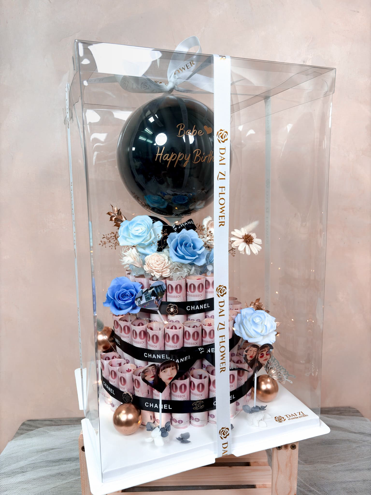 全客製化永生花鈔票蛋糕專屬透明禮盒包裝，DAI ZI FLOWER STUDIO 代紫花藝嚴選質感品牌白緞帶，讓這款結合藍色玫瑰與有錢花設計的絕美作品，成為質感滿分的極致浪漫禮物。