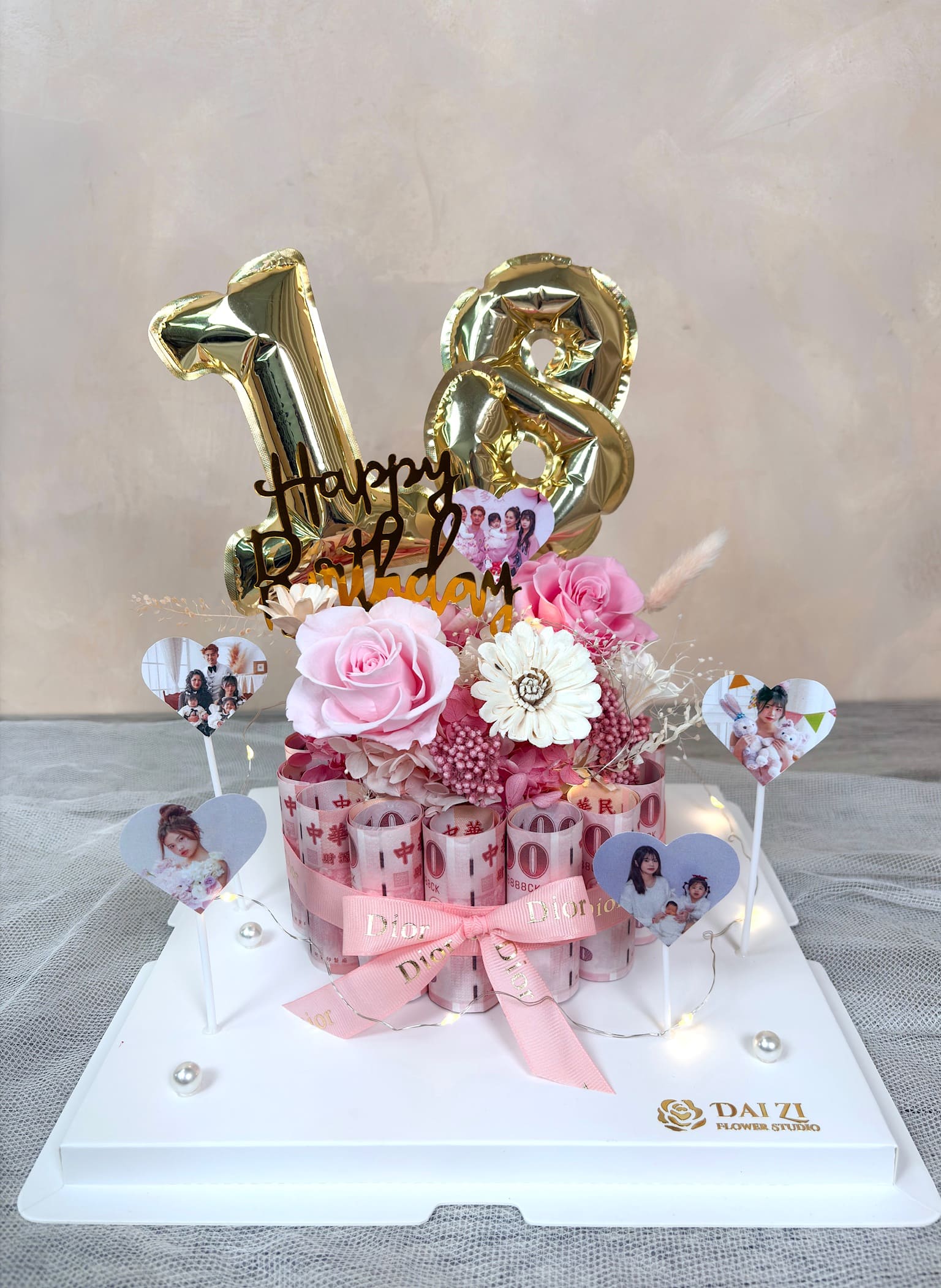 大台北高質感花店 DAIZI代紫花藝專屬客製化18歲生日浪漫禮物，以粉色系永生玫瑰結合百元鈔票打造絕美永生花鈔票蛋糕，搭配專屬照片插牌與數字氣球，呈現有錢花頂級驚喜。